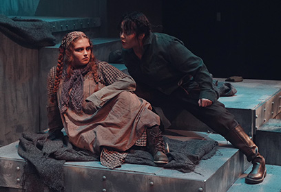 Two performers on stage acting