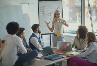 Professional woman giving a presentation to her staff.