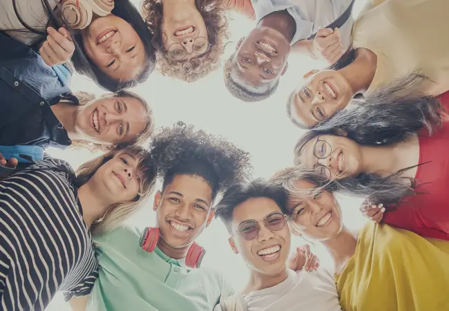 Group of students standing in a circle.