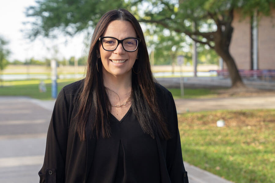 Photo of Alycia outside of the Admin building.