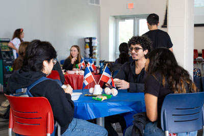 Students at a table at event.